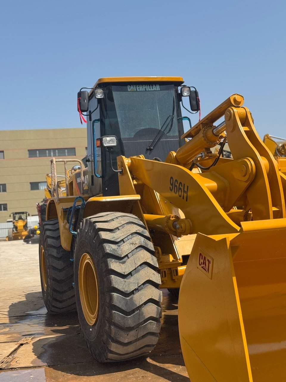 Caterpillar 966H wheel loader, front low-angle view of cab and bucket